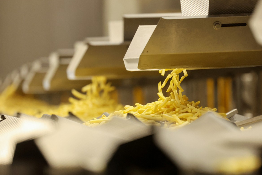 Fries are sorted in the grading room of the Clarebout factory a French producer of frozen potato products in Bourbourg, near Dunkirk, northern France, on February 25, 2025. (Photo by FRANCOIS LO PRESTI / AFP)