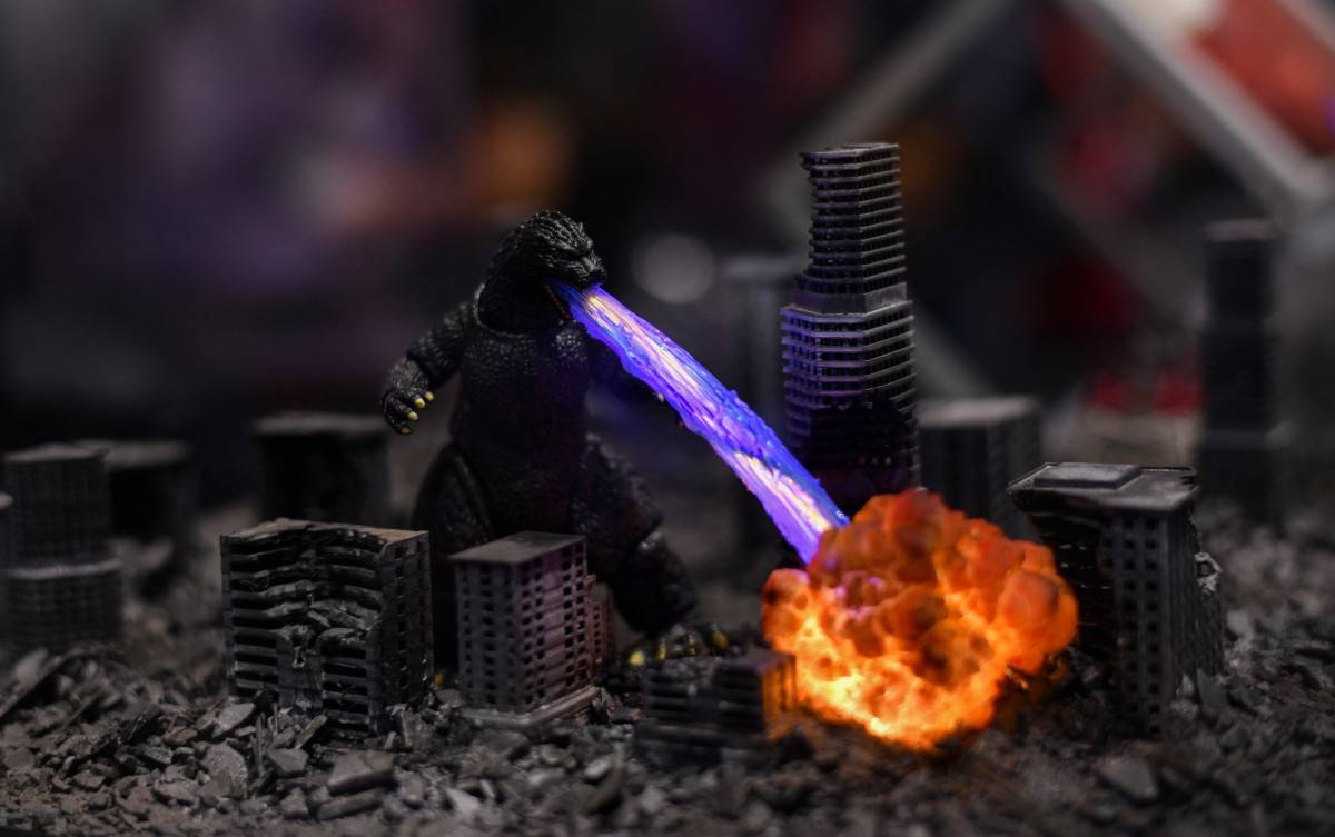 A miniature Godzilla is displayed at the Bandai booth during Comic-Con International in San Diego, California, on July 26, 2025. (Photo by Chris DELMAS / AFP)