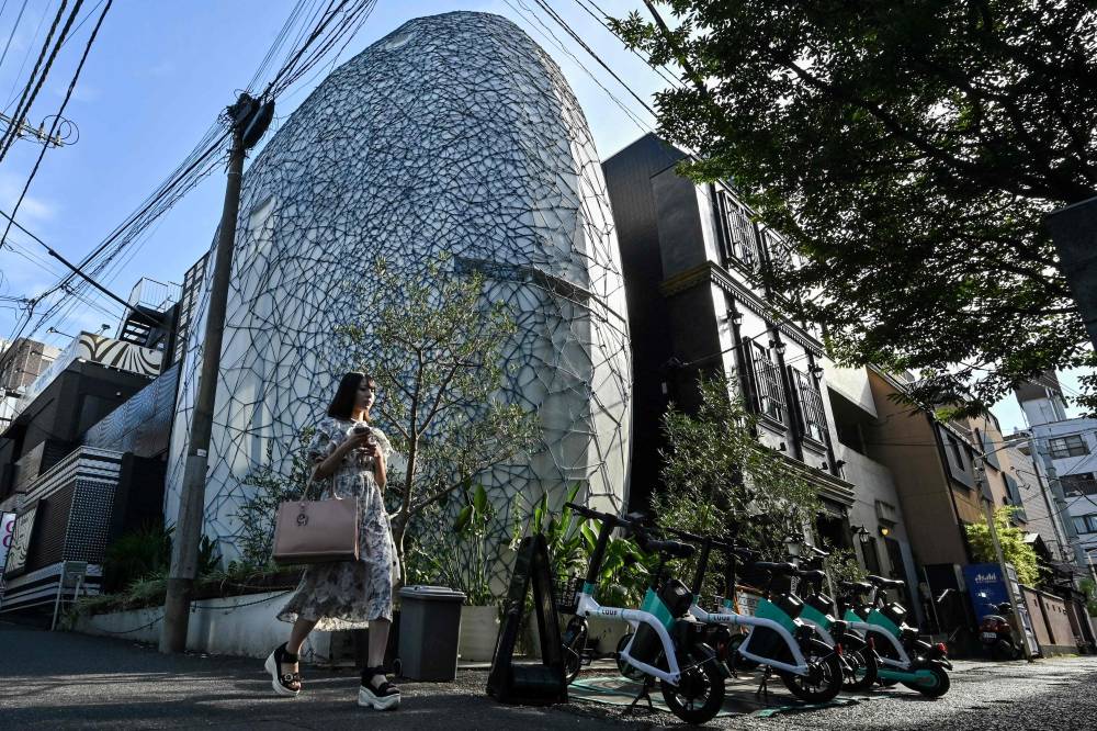 A pedestrian walking past an egg-shaped home