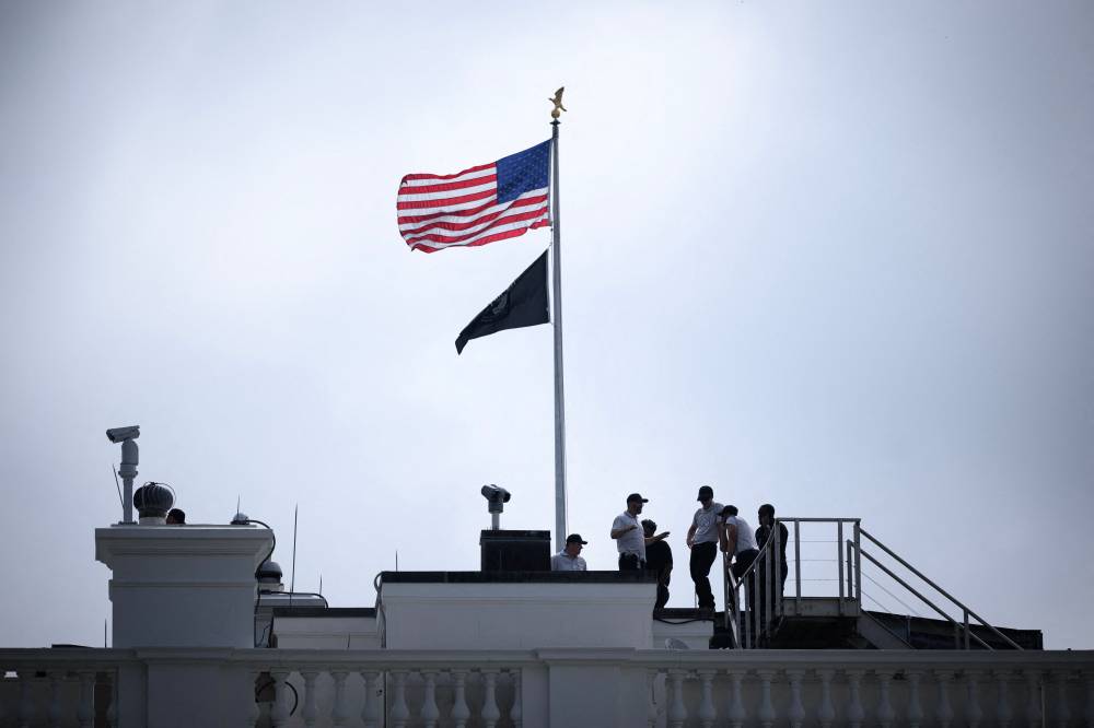 The US flag flies above the White House in Washington, DC. Photo by Mandel Ngan/AFP