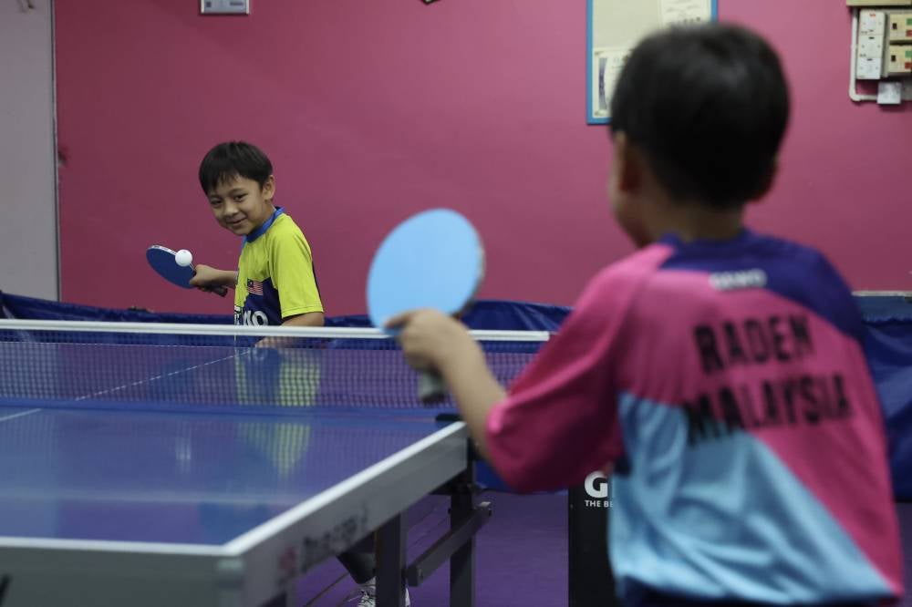 Siblings Habib Adrian Muhamad Suhaidin Azhar Bidin@Jamaludin and Raden Zharif during a training session at the MSA Sport Table Tennis Centre. Photo by Bernama