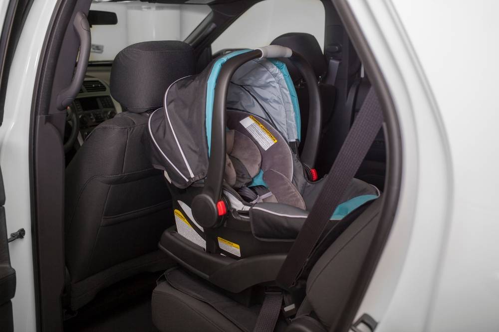 With preparation and smart techniques, parents can turn the daily struggle of getting a toddler into a car seat into a smoother experience. Photo: Edited via Canva