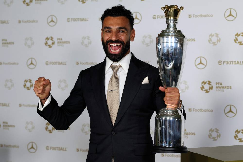 Liverpool's Egyptian striker Mohamed Salah poses with the Men's PFA Players' Player of the Year award backstage during the 2024-2025 Professional Footballers' Association (PFA) awards, at the Opera House in Manchester, northern England, on August 19, 2025. (Photo by Darren Staples / AFP)