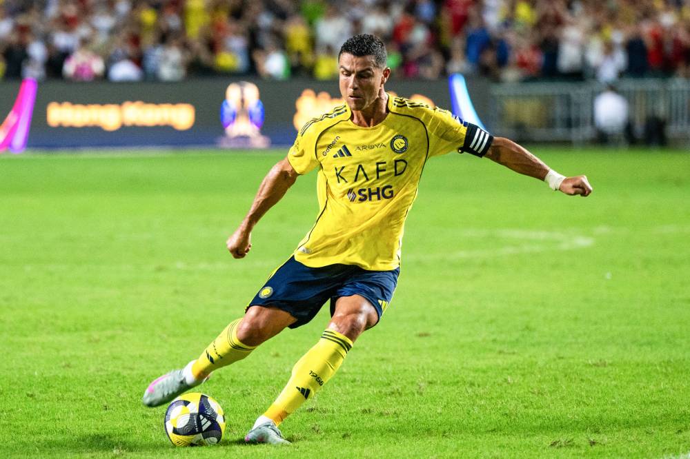 Al-Nassr's Cristiano Ronaldo shoots on goal during the Saudi Super Cup semi-final football match between Al-Nassr and Al-Ittihad at the Hong Kong Stadium in Hong Kong on August 19, 2025. (Photo by Wun Suen / AFP)