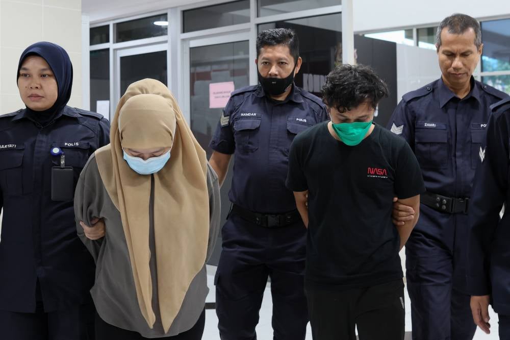 Labourer Mohammad Saiful Ikhwan Abdul Rahman, 27, and his wife Nor Azila Sharif Ahmad, 30, who are the victim’s biological father and stepmother, respectively, pleaded not guilty to the charge, which was read out separately to them before Judge Mohd Zul Zakiqudin Zulkifli. Photo by Bernama