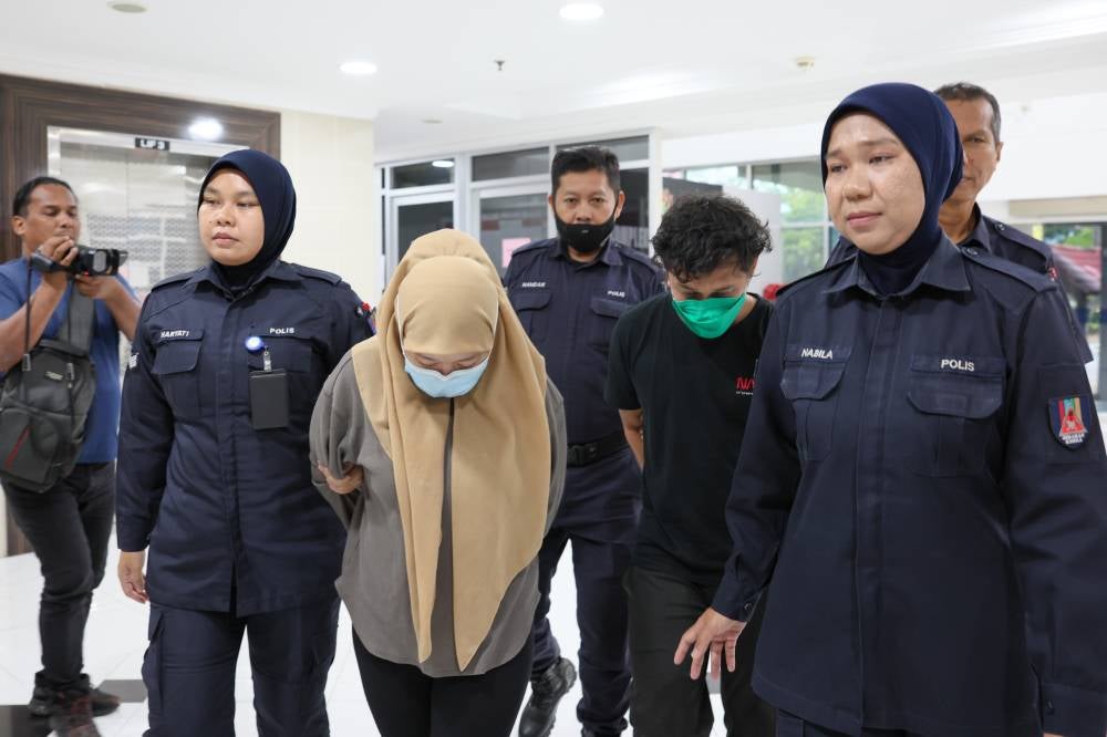 Labourer Mohammad Saiful Ikhwan Abdul Rahman, 27, and his wife Nor Azila Sharif Ahmad, 30, who are the victim’s biological father and stepmother, respectively, pleaded not guilty to the charge, which was read out separately to them before Judge Mohd Zul Zakiqudin Zulkifli. Photo by Bernama