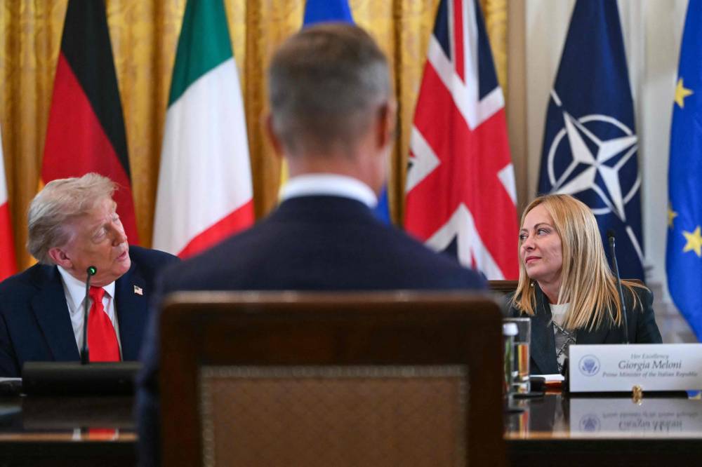 (L/R) US President Donald Trump, Finnish President Alexander Stubb and Italian Prime Minister Giorgia Meloni participate in a meeting with Ukrainian President Volodymyr Zelensky and European leaders in the East Room of the White House in Washington, DC, on August 18, 2025. (Photo by ANDREW CABALLERO-REYNOLDS / AFP)