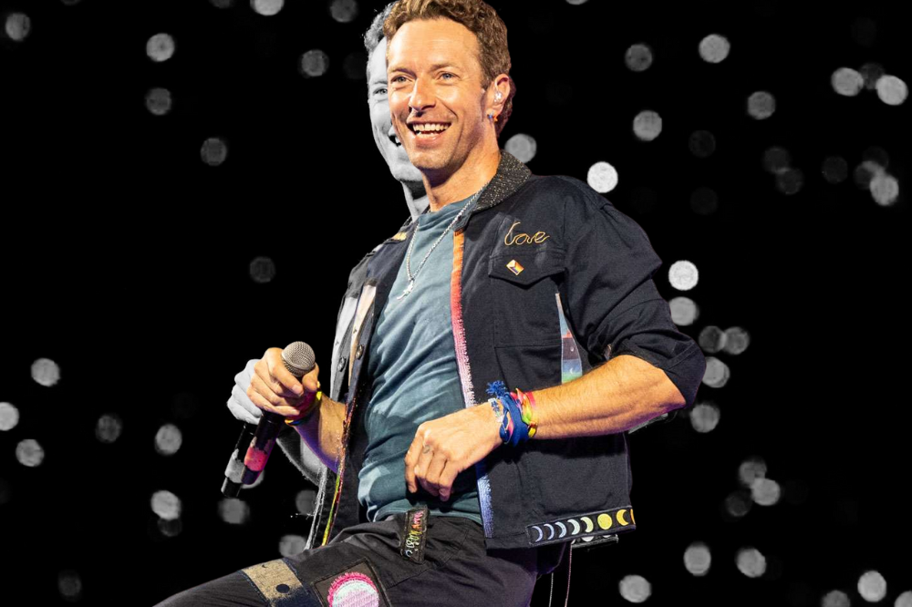 Chris Martin of Coldplay performs onstage at Wembley Stadium. - Photo: edited in CANVA