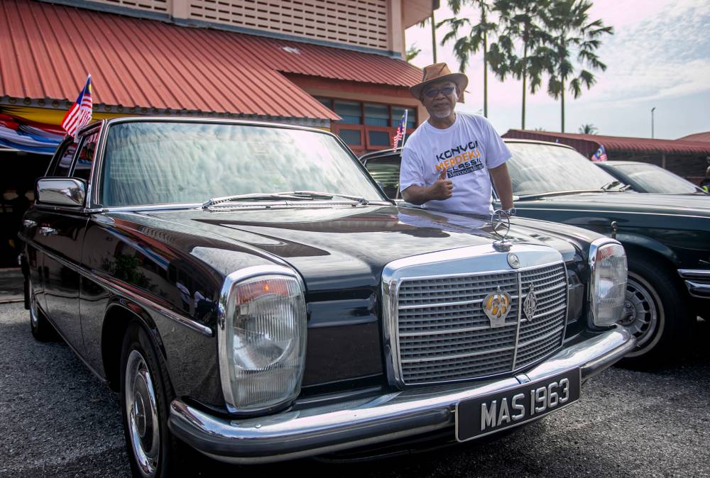 Perak Mercedes-Benz Motor Recreation Club (GPMP) advisor Masaud Mansor, 62, posing with his Mercedes-Benz Model 115 E Series during the Merdeka Classic Mercedes Convoy Programme at Sekolah Menengah Kebangsaan Layang-Layang Kiri recently. - Bernama photo