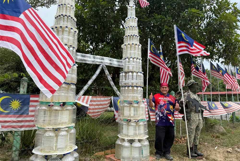 Nasaruddin poses with his KLCC replica made from recycled plastic bottles, along with a display of his old military uniform at his house in Kampung Simpang Air Mawar, Johol.