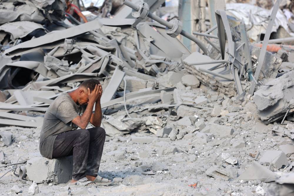 A Palestinian man reacts to the destruction after an overnight strike on the Sheikh Radwan Health Centre in the north of Gaza City on Aug 6, 2025. (Photo by Omar AL-QATTAA / AFP)