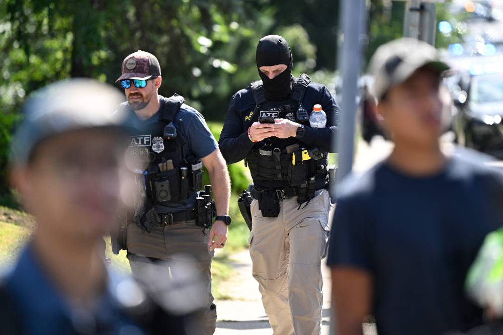 Bureau of Alcohol, Tobacco, Firearms and Explosives (ATF) agents survey the scene following a mass shooting at Annunciation Catholic Church on Aug 27, 2025 in Minneapolis, Minnesota. - (Photo by Stephen Maturen / Getty Images via AFP)