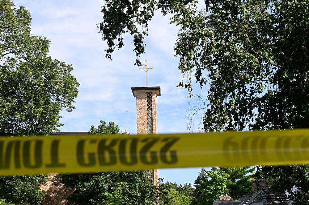 The Annunciation Catholic Church is seen behind police tape following a mass shooting on Aug 27, 2025 in Minneapolis, Minnesota. - (Photo by Stephen Maturen / Getty Images via AFP)