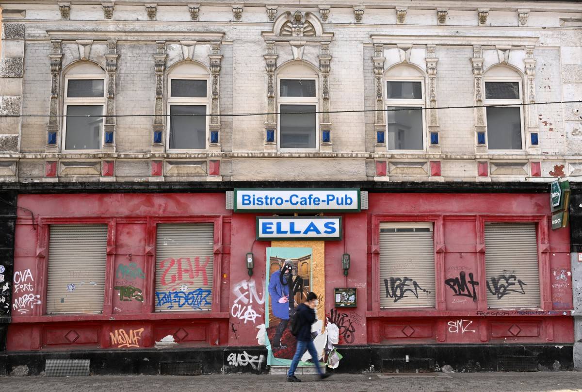 A man walks past a former pub in Ueckendorf district, Gelsenkirchen, western Germany on August 27, 2025. (Photo by Ina FASSBENDER / AFP)