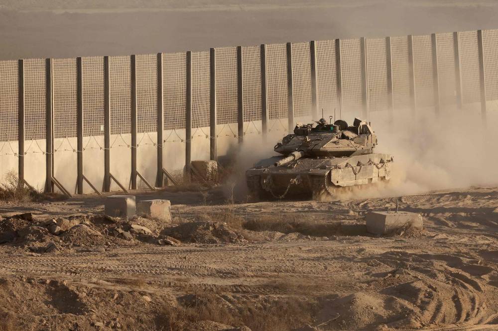 An Israeli army tank rolls near the border with the Gaza Strip in southern Israel, on Aug 29. Photo by Jack Guez/AFP
