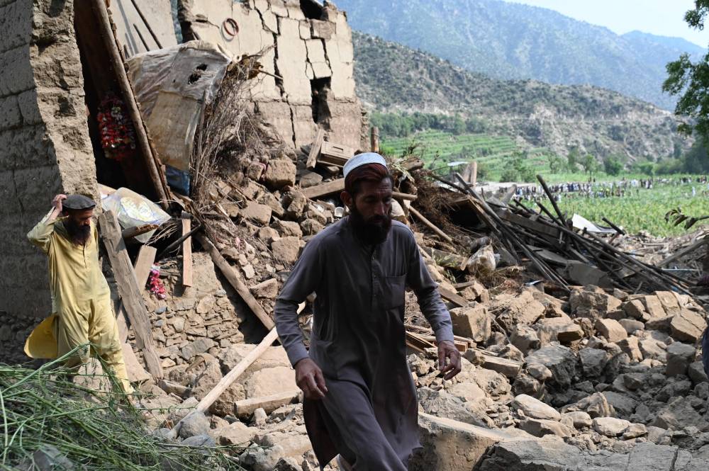 An Afghan man walks past a damaged house following earthquakes in the Mazar Dara village of Nurgal, a district of the Kunar Province, in Eastern Afghanistan, on Sept 1, 2025. - (Photo by Wakil Kohsar / AFP)