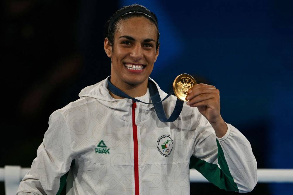 Gold medallist Algeria's Imane Khelif poses on the podium during the medal ceremony for the women's 66kg final boxing category during the Paris 2024 Olympic Games at the Roland-Garros Stadium, in Paris on Aug 9, 2024. - (Photo by MAURO PIMENTEL / AFP)