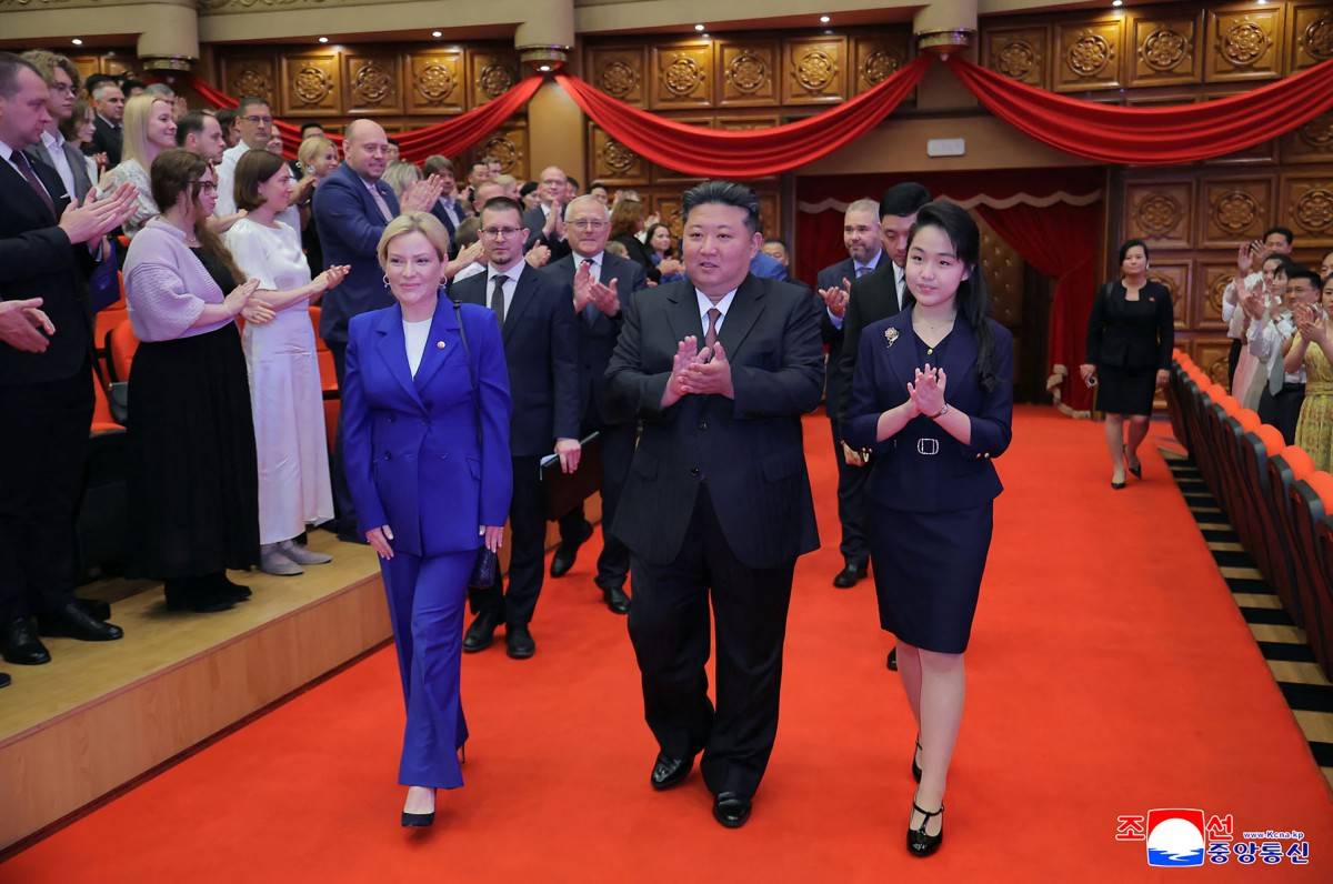 This picture taken on June 29, 2025 and released by North Korea's official Korean Central News Agency (KCNA) on June 30, 2025 shows North Korean leader Kim Jong Un (C) and his daughter Kim Ju-ae (R) entering with Russian Minister of Culture Olga Lyubimova (L) to watch a performance by Russian and North Korean entertainers at the East Pyongyang Grand Theatre in Pyongyang. (Photo by KCNA VIA KNS / AFP)