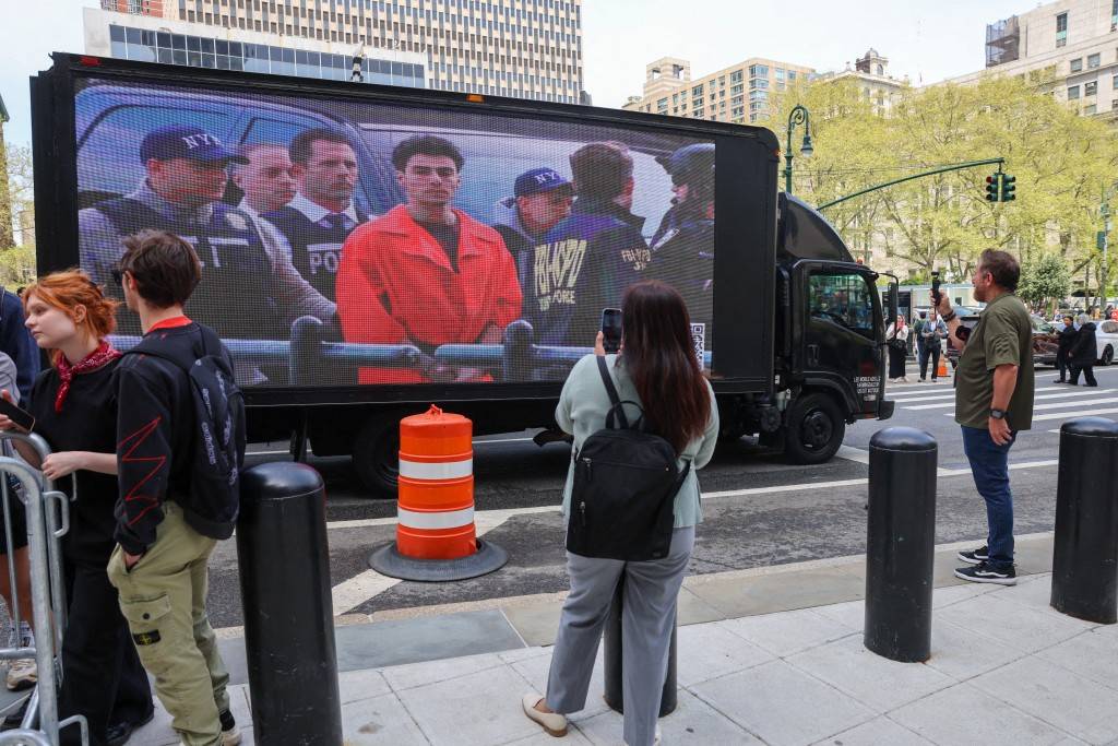 A truck displays pictures of Luigi Mangione as his supporters gather outside a federal court in Manhattan as the murder suspect is set to appear for the arraignment on charges that he murdered UnitedHealthcare chief executive Brian Thompson late last year on April 25, 2025 in New York City. - (Photo by SPENCER PLATT / GETTY IMAGES NORTH AMERICA / Getty Images via AFP)