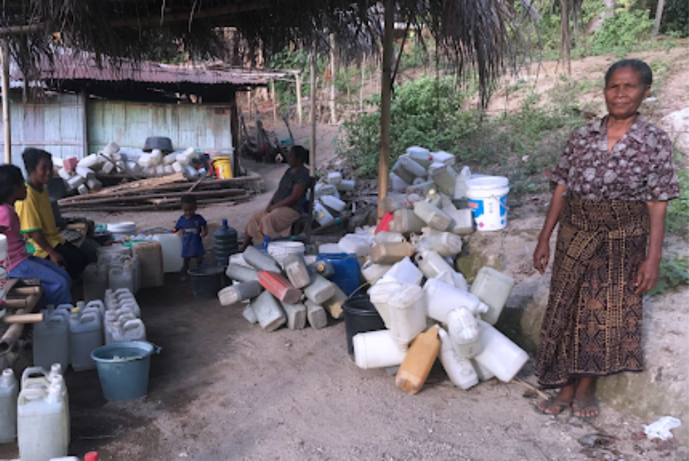 Maria Fatima Bunga while queuing for water at Ae Wuka springs for daily needs. Photo by Aliansi Kolibri.