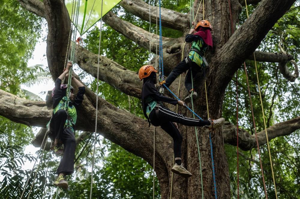 Putri Nur Aisyah Mohamad Rizal, 14, Nur Husna Safiya Mohd Zulhusmi, 13, and her younger sister, Nur Hanis Syuhada Mohd Zulhusmi, 11, have been participating in the activity since the age of seven. - Bernama photo