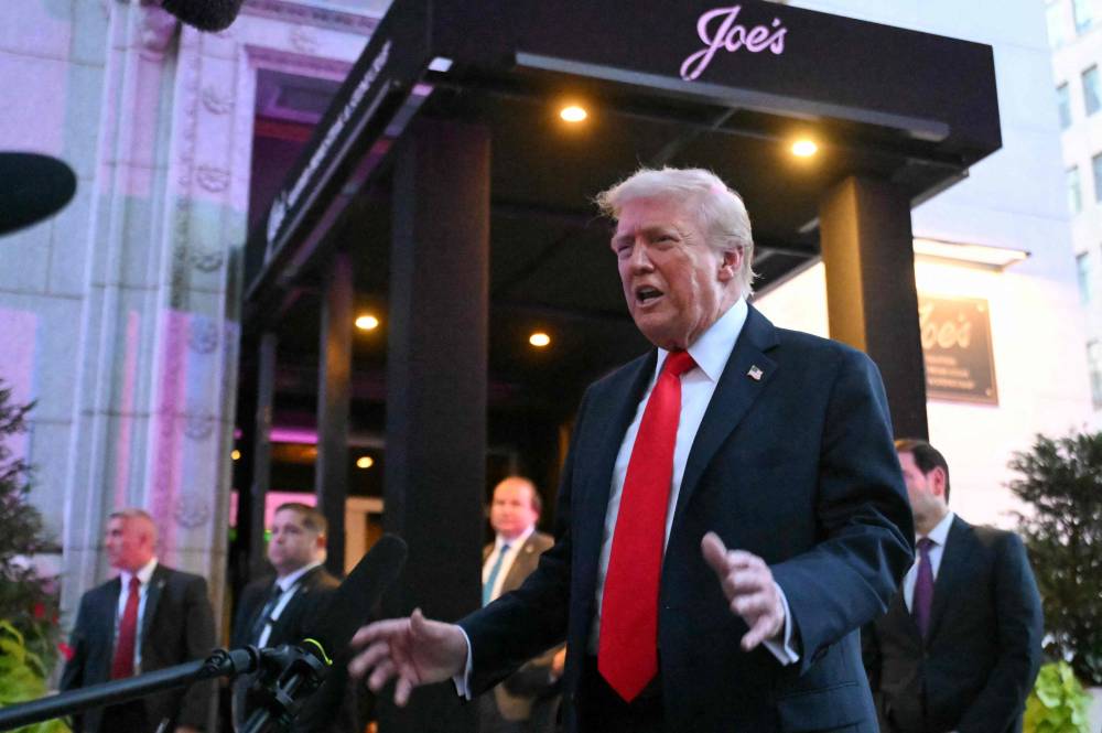 US President Donald Trump speaks to reporters outside a restaurant in Washington, DC, on Sept 9, 2025. - (Photo by SAUL LOEB / AFP)