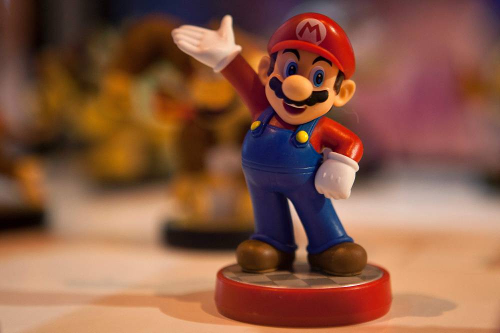 (FILES) This file photo taken on October 2, 2015 shows a figurine representing Japanese multinational Nintendo's famous video game character Mario Bros on display during the Madrid Games Week 2015 in Madrid. Over four decades Nintendo's mascot "Super Mario" has run and jumped his way to global stardom, broadening the appeal of the video game industry as one of its top characters. September 13, 2025 will mark the 40th anniversary of the release of the 'Super Mario Bros' video game by Japanese video game maker Nintendo. (Photo by SEBASTIEN BERDA / AFP) / TO GO WITH Japan-games-Nintendo-Mario,FACTS by Mathias CENA