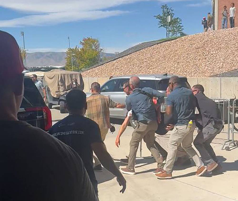 This screen grab from a video by Jeremy King shows security personnel carrying right-wing youth activist and influencer Charlie Kirk after he was shot during a public event at Utah Valley University in Orem, Utah, on Sept 10, 2025. - (Photo by JEREMY KING / UGC / AFP)