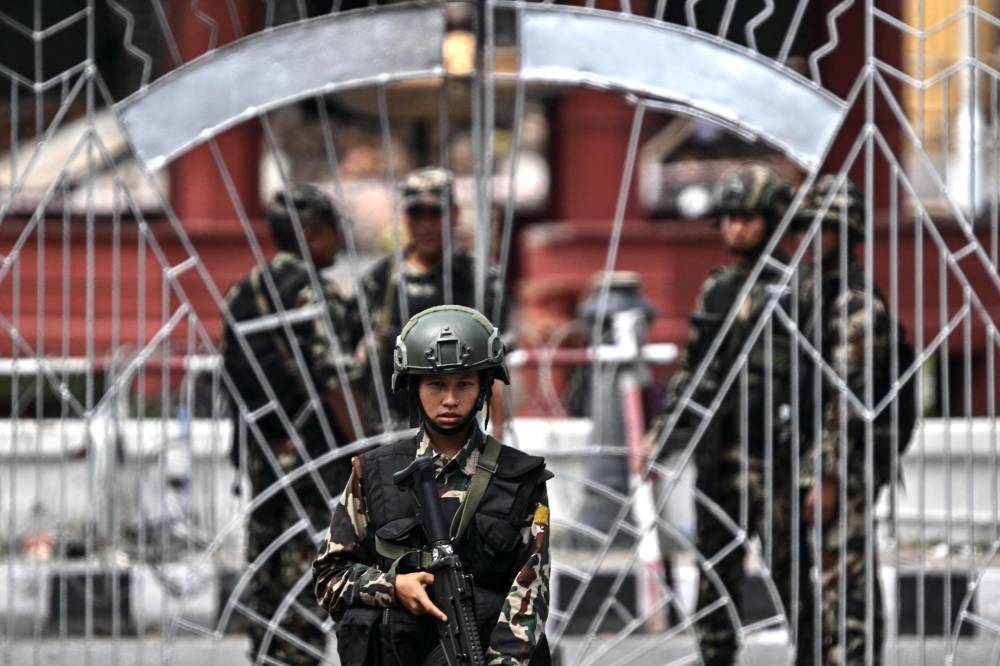 An army personnel keeps watch outside Nepal's President House during a curfew imposed to restore law and order in Kathmandu on Sept 12, 2025. - (Photo by Pedro Pardo / AFP)