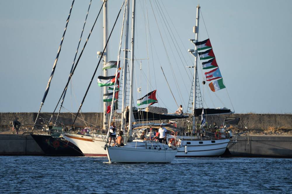 Activists taking part in the Global Sumud Flotilla, bound for the Gaza Strip to break Israel's blockade on the Palestinian territory, ride aboard a sailboat departing from Tunisia's northern port of Bizerte on Sept 13, 2025. - (Photo by FETHI BELAID / AFP)