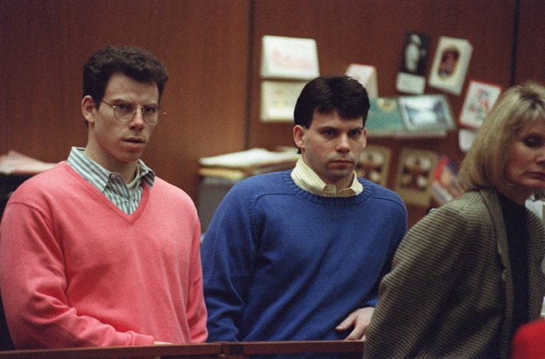 Erik Menendez (L) and his brother Lyle (R) listen during a pre-trial hearing, on Dec 29, 1992 in Los Angeles after the two pleaded innocent in the August 1989 shotgun deaths of their wealthy parents, Jose and Mary Louise Menendez of Beverly Hills, Calif. - (Photo by VINCE BUCCI / AFP)