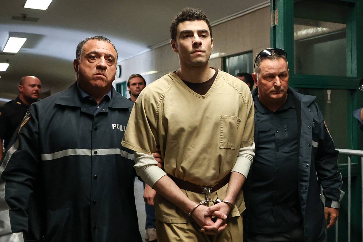 Luigi Mangione, accused of the murder of United Healthcare CEO Brian Thompson, is escorted by police as he arrives at court in New York City on Sept 16, 2025. - (Photo by TIMOTHY A.CLARY / AFP)