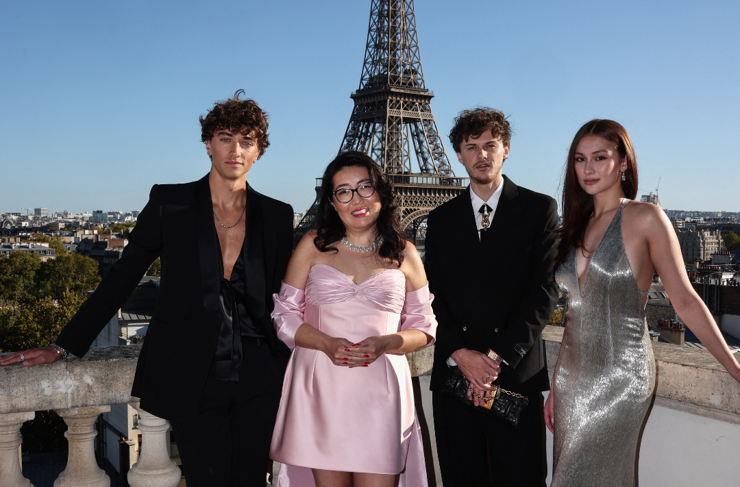 From left: Gavin Casalegno, Jenny Han, Christopher Briney and Lola Tung pose during a photocall on the roof of the Shangri-La Hotel prior to a special screening of the final episode of the serie "The Summer I Turned Pretty", in Paris, on Sept 17, 2025.