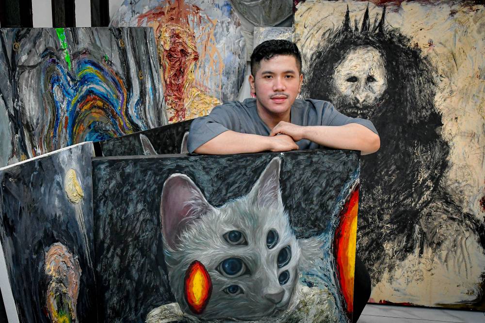 Artist Aiman Zamri, 29, poses with his surrealist paintings at his home in Bandar Puteri Klang, recently. Photo by Bernama