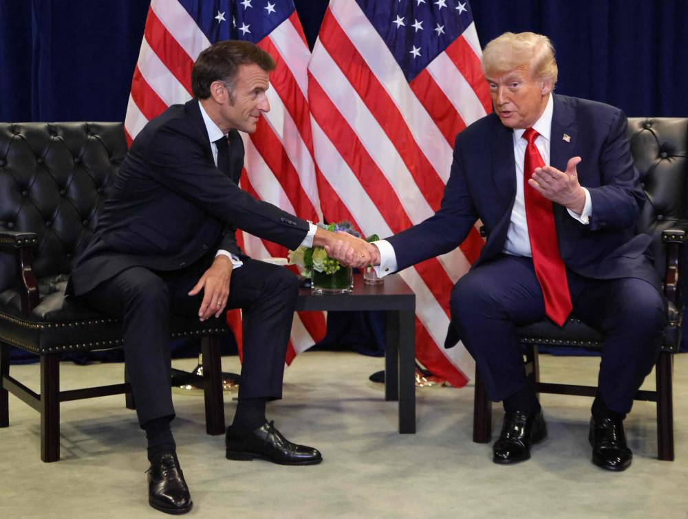US President Donald Trump and France's President Emmanuel Macron shake hands as they hold a bilateral meeting on the sidelines of the United Nations General Assembly in New York City. Photo by Ludovic Marin/AFP