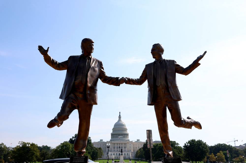 A statue depicting US President Donald Trump and Jeffrey Epstein holding hands is seen in Washington, DC. Photo by AFP.