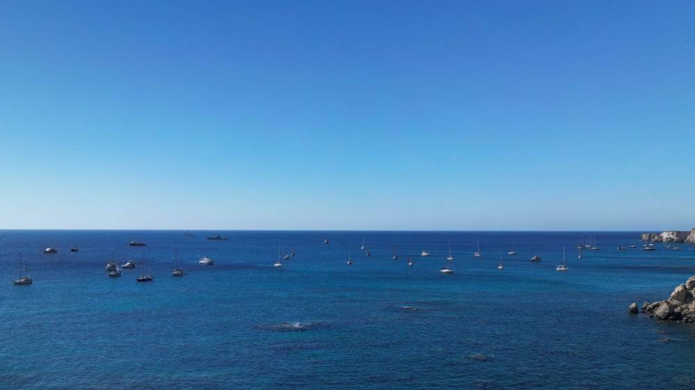 A group of ships of the Global Sumud Flotilla to Gaza are shown moored at the small island of Koufonisi, south of the island of Crete on Sept 26, 2025. - (Photo by Eleftherios Elis / AFP)