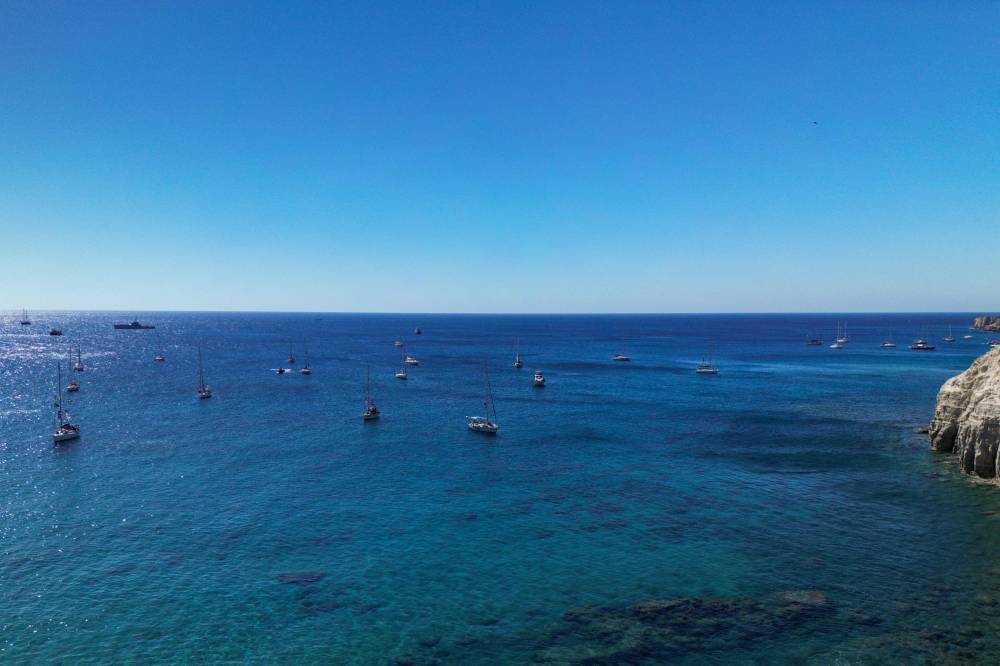 A group of ships of the Global Sumud Flotilla to Gaza are shown moored at the small island of Koufonisi, south of the island of Crete on Sept 26, 2025. - (Photo by Eleftherios Elis / AFP)