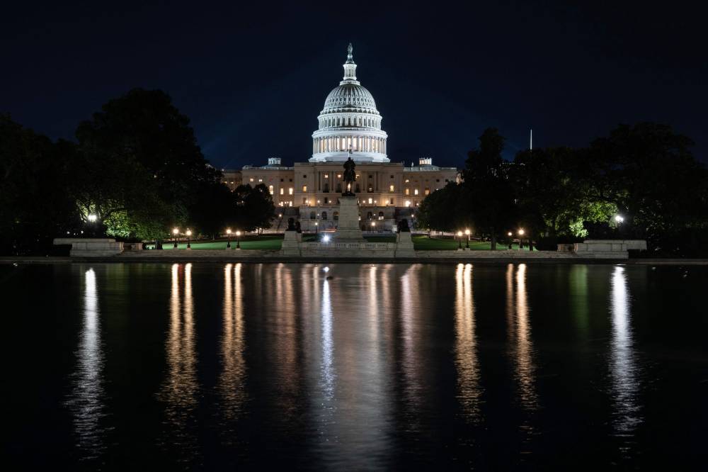 The US Capitol is seen lit up hours before a partial government shutdown is set to take effect in Washington, DC. Photo by Andrew Caballero - Reynolds/AFP