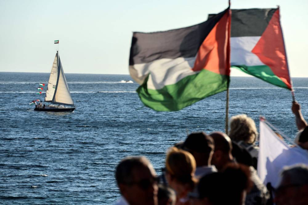 Activists wave palestinian flags as they gather to support a flotilla carrying humanitarian aid and activists vowing to try "to break the siege of Gaza", in Ajaccio, on the French Mediterranean island of Corsica, on Sept 12, 2025. (Photo by Pascal POCHARD-CASABIANCA / AFP)