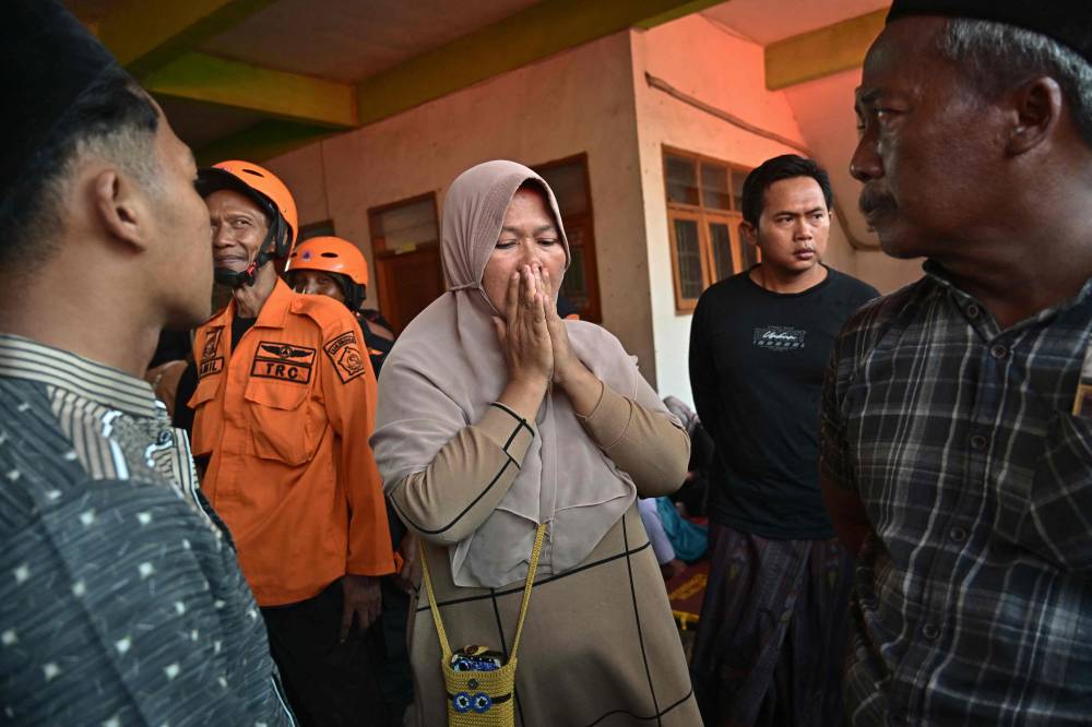 Relatives of missing students gather as search and rescue operations continue at Al Khoziny Islamic boarding school in Sidoarjo, East Java province, after the multi-storey school building collapsed two days earlier. Photo by Juni Kriswanto/AFP
