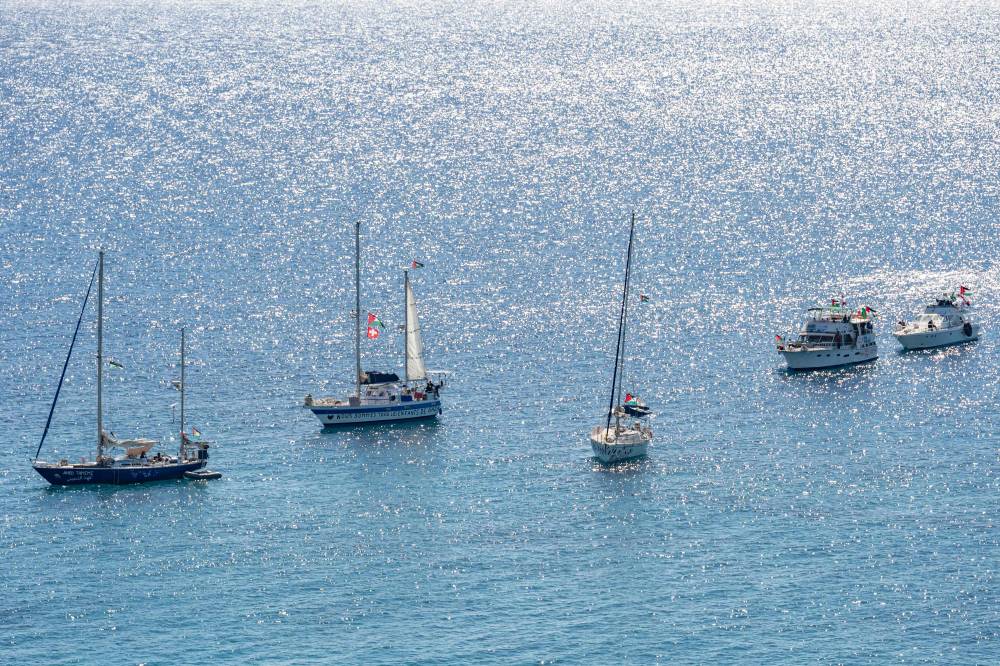 A group of ships of the Global Sumud Flotilla to Gaza are shown moored at the small island of Koufonisi, south of the island of Crete on Sept 26. Photo by Eleftherios Elis/AFP