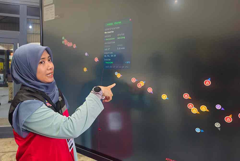 Adibah pointing to the location of the vessel Marinette as it sails towards Gaza.
