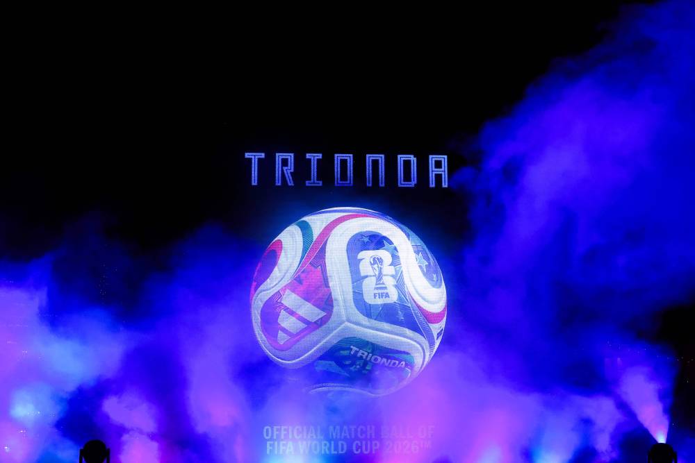 A large video screen shows the 2026 FIFA Men's World Cup match ball named Trionda during its unveiling in New York on October 2, 2025. The 2026 FIFA Men's World Cup is scheduled to take place between June and July 2026, with matches being hosted in Mexico, Canada and the US. (Photo by CHARLY TRIBALLEAU / AFP)