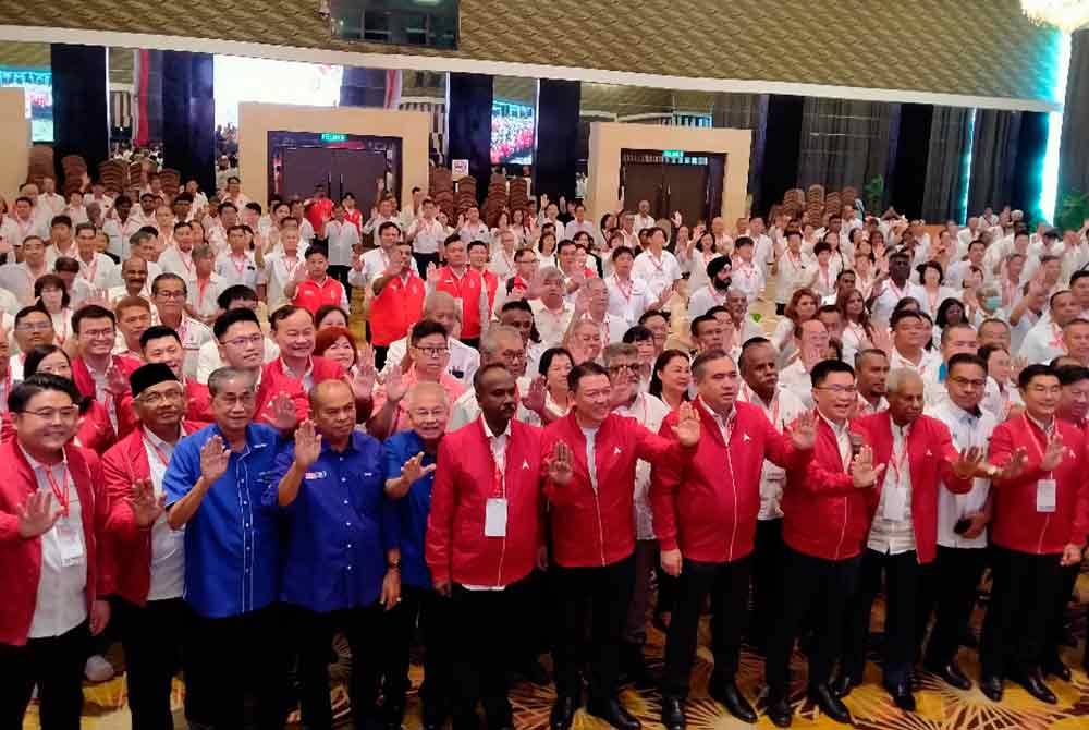 Loke (fifth from right) with guests and delegates attending the 23rd Perak DAP annual convention at a hotel in Ipoh on Sunday.