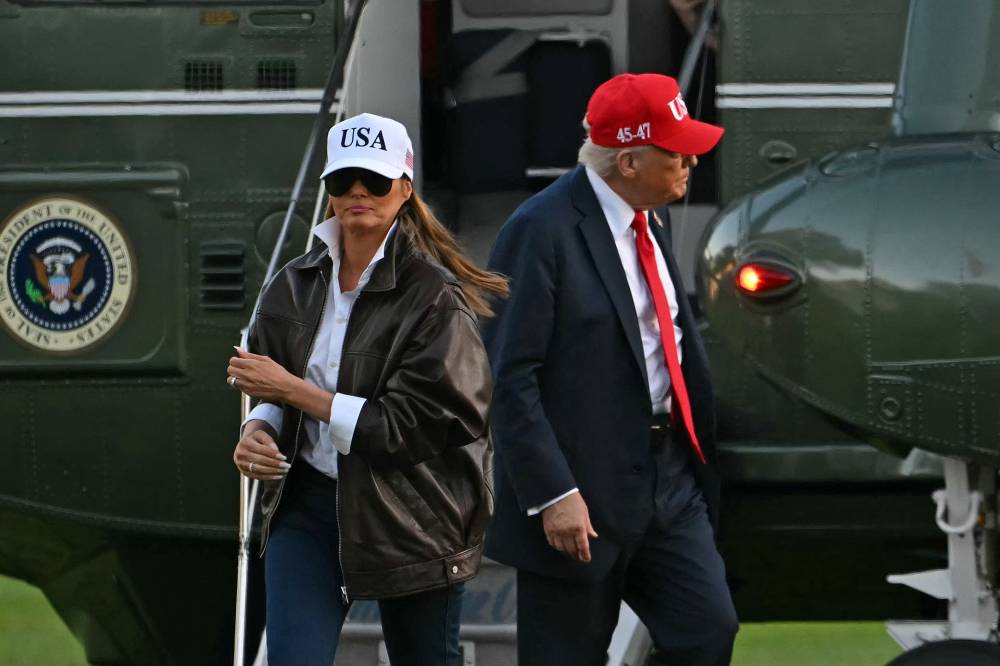 US President Donald Trump and US First Lady Melania Trump step off Marine One on the South Lawn of the White House in Washington, DC, on October 5, 2025. Trump is returning from Norfolk where he attended the US Navy's 250th anniversary celebrations. (Photo by ANDREW CABALLERO-REYNOLDS / AFP)