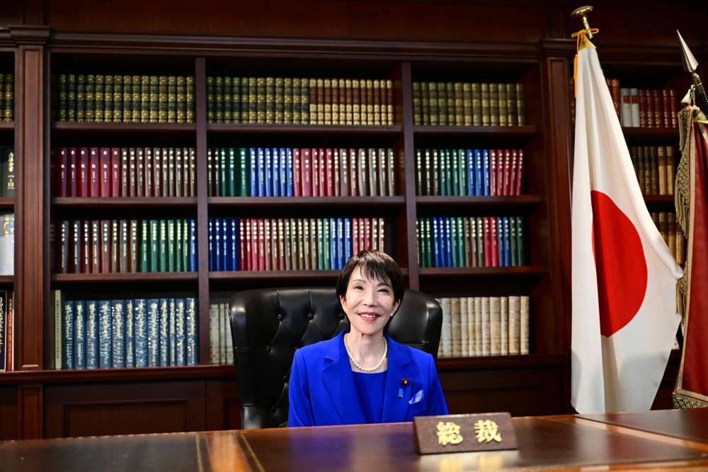 Sanae Takaichi, the newly elected leader of Japan's ruling party, the Liberal Democratic Party poses in the party leader's office after the LDP leadership election in Tokyo on Oct 4, 2025. - (Photo by Yuichi Yamazaki / POOL / AFP)