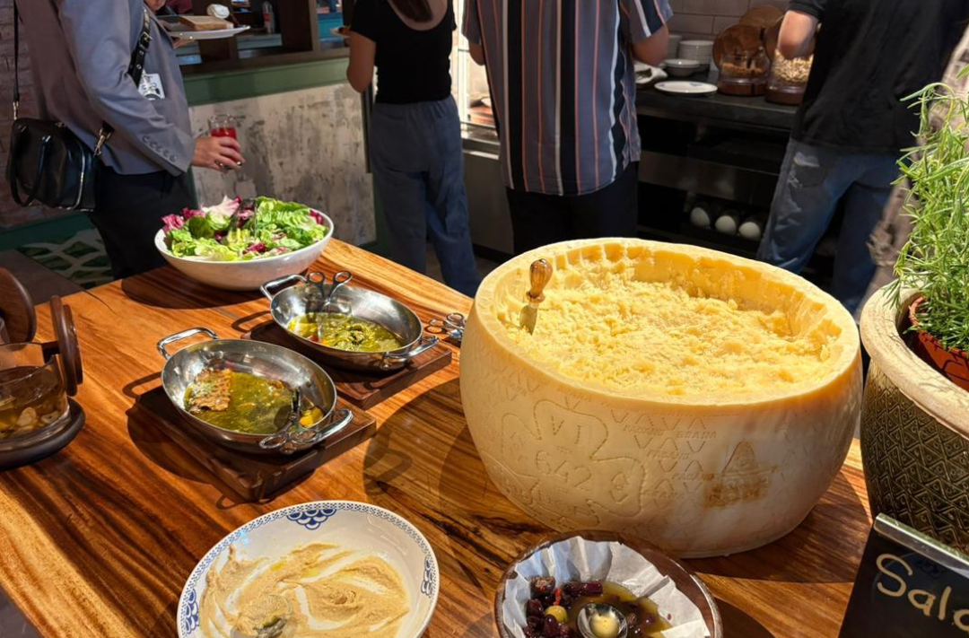 The cheese wheel at Il Forno lets you shave off as much creamy goodness as you please, adding a touch of Italian flair to your morning salad.