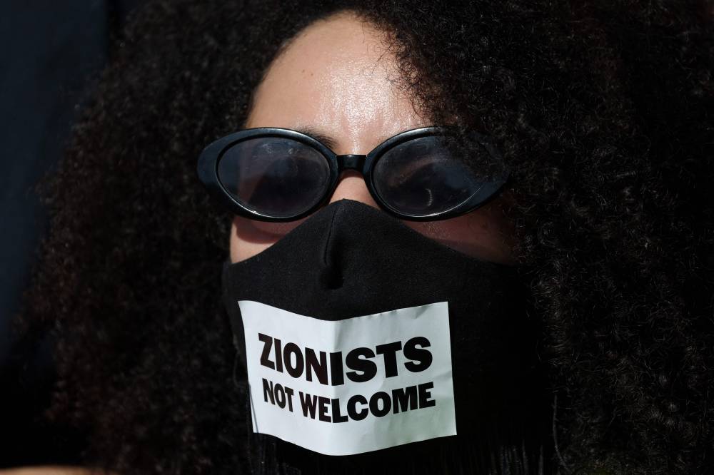 Participants march during a demonstration in solidarity with Palestinians in Barcelona on October 4, 2025. (Photo by Lluis GENE / AFP)