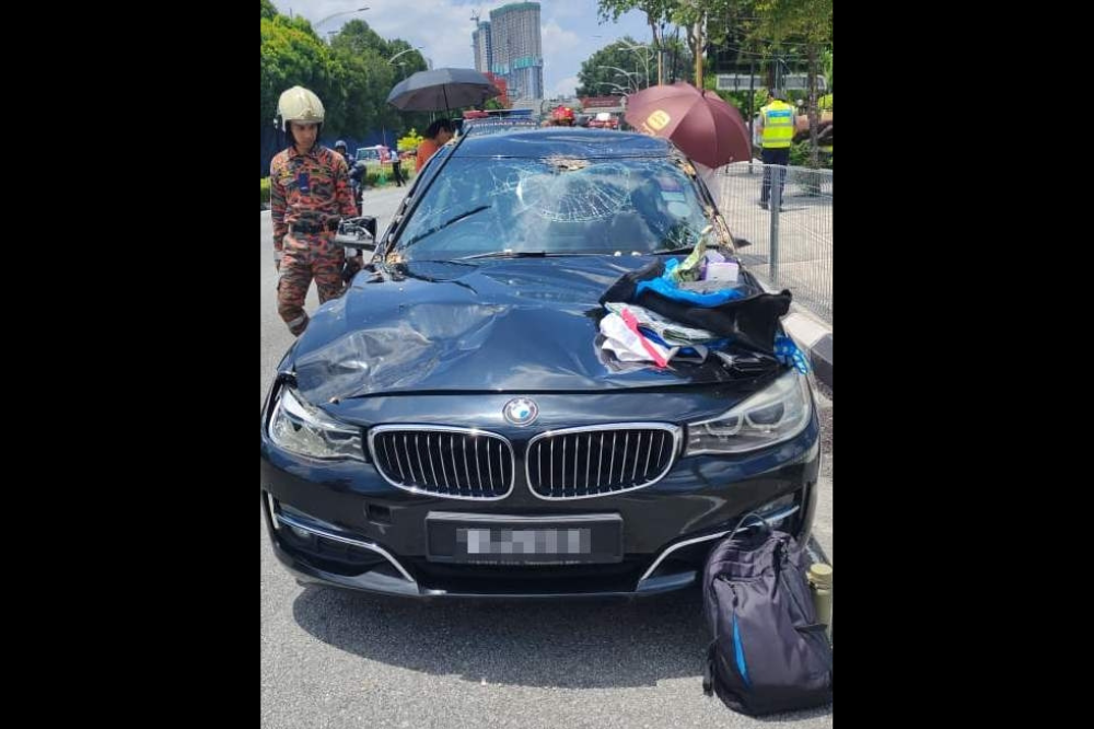 A BMW car was crushed by a tree along Jalan Tun Razak, Kuala Lumpur, on Wednesday. -Photo: Kuala Lumpur Fire and Rescue Department (JBPM).